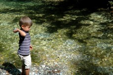 G tossing rock in river, Ribnica